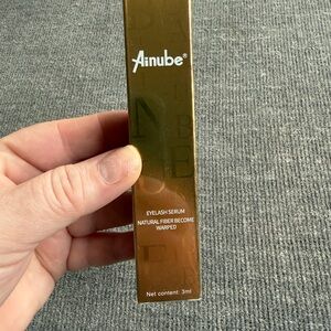 Ainube Eyelash Serum in Shiny Brown-Gold Box
